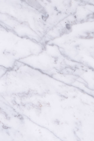 Close-up of veining on white Carrara marble coffee table. 