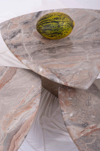 Close-up of the three vintage marble tables with melon on top