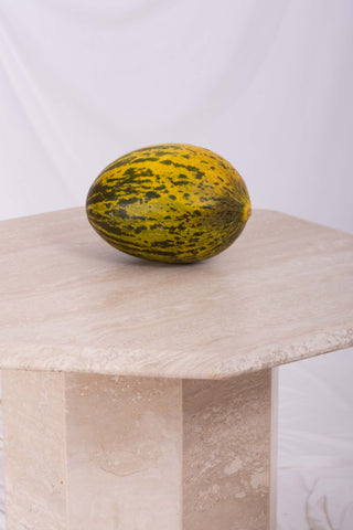 Close-up shot of one coffee table with melon on top 