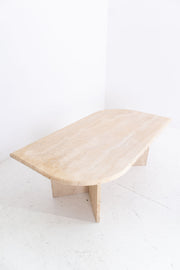 travertine coffee table on a white floor with a white wall background