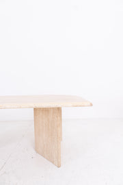 Minimalist travertine table on a white background
