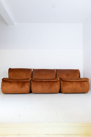 Modular vintage brown sofa against a white wall
