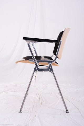 Metal framed vintage Italian stacking chair against a white backdrop.