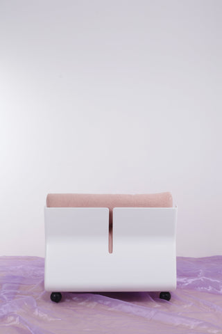 Retro Bellini armchair with a white frame and pink upholstery against a white background and purple floor