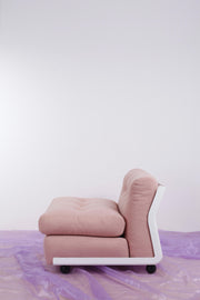 retro pink Italian chair with white frame against a plain background and a purple chiffon floor covering
