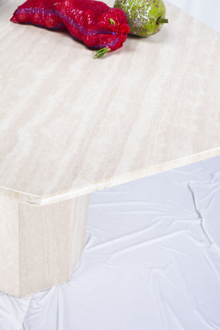 Detailed overhead shot of the travertine dining table