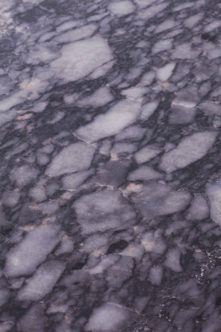 Close up of veining on vintage grey marble dining table.