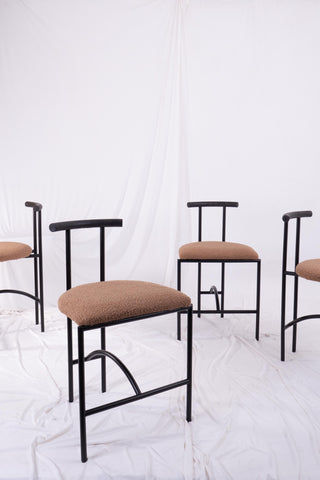 Set of four Tokyo dining chairs by Rodney Kinsman. White draped fabric in the background