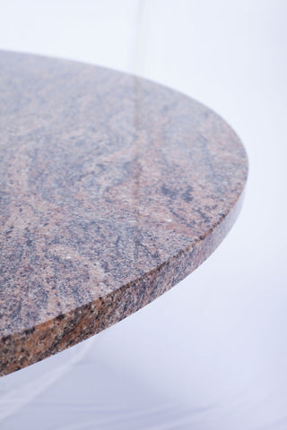 Close up of edge of round granite dining table top