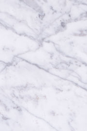 Close-up of veining on white Carrara marble coffee table. 