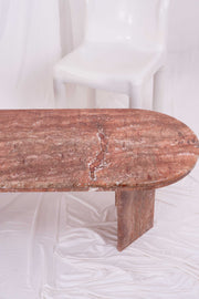 Close up of repairs to this retro marble coffee table. Shot in front of a white plastic chair and white drapes.