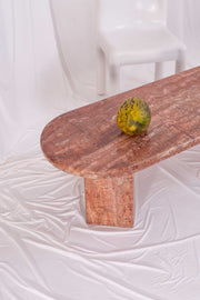 Image of a melon on top of a vintage orange marble coffee table.